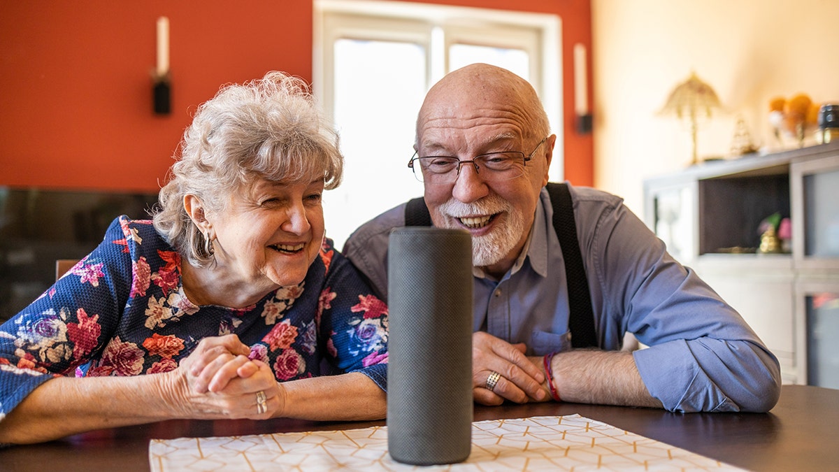 Bigger couple interacting with a smart home device