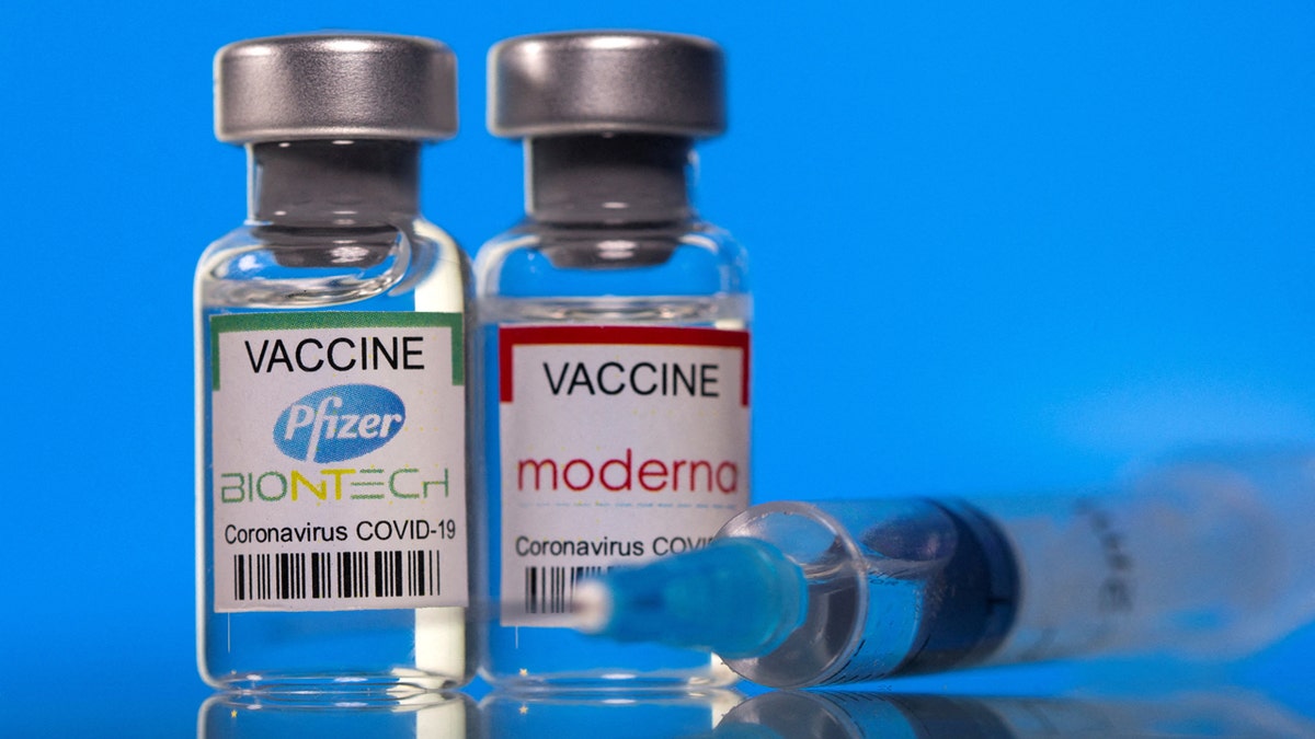 The roads with the Pfizer-Biontech and Modern Coronavirus vaccine (Covid-19) are seen on a blue background.