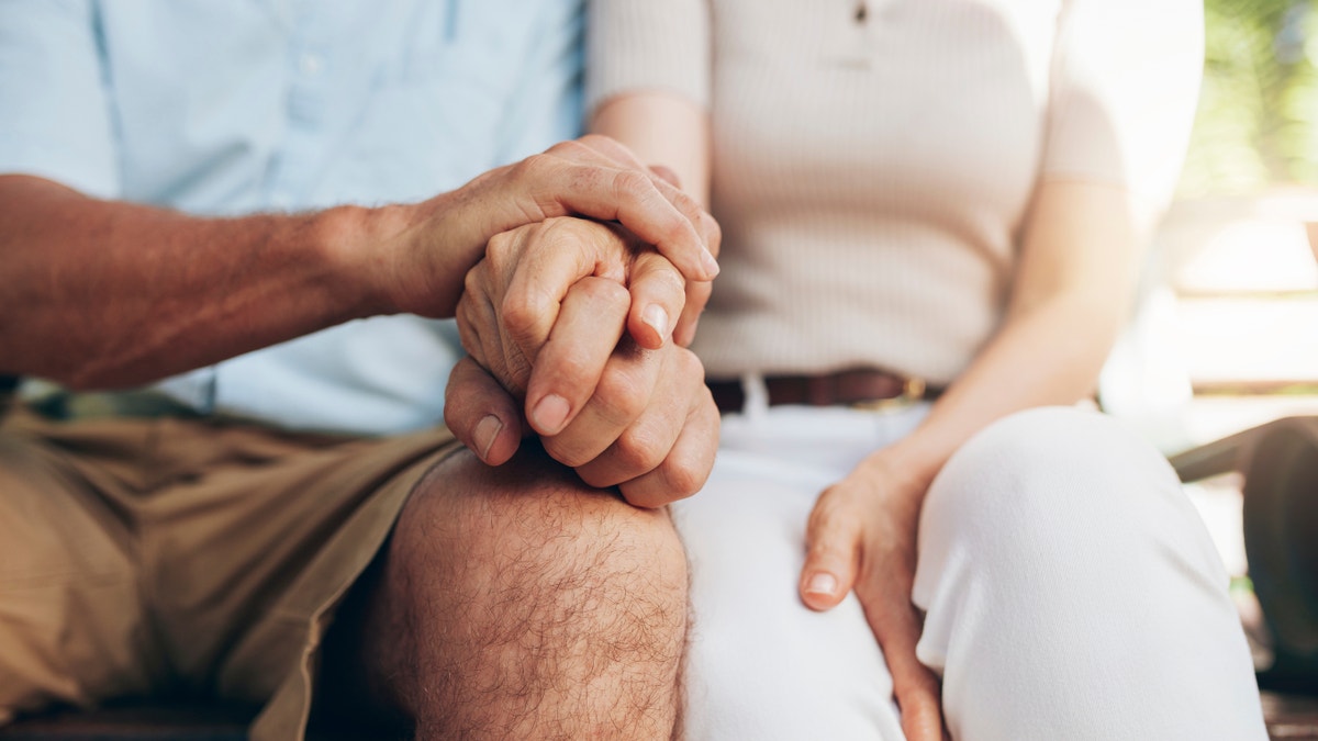 The senior couple who had his hand. Love couple sitting together and holding hands. Focus on your hands.
